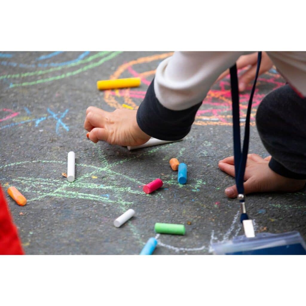 Child chalk drawing outdoor summer art activity